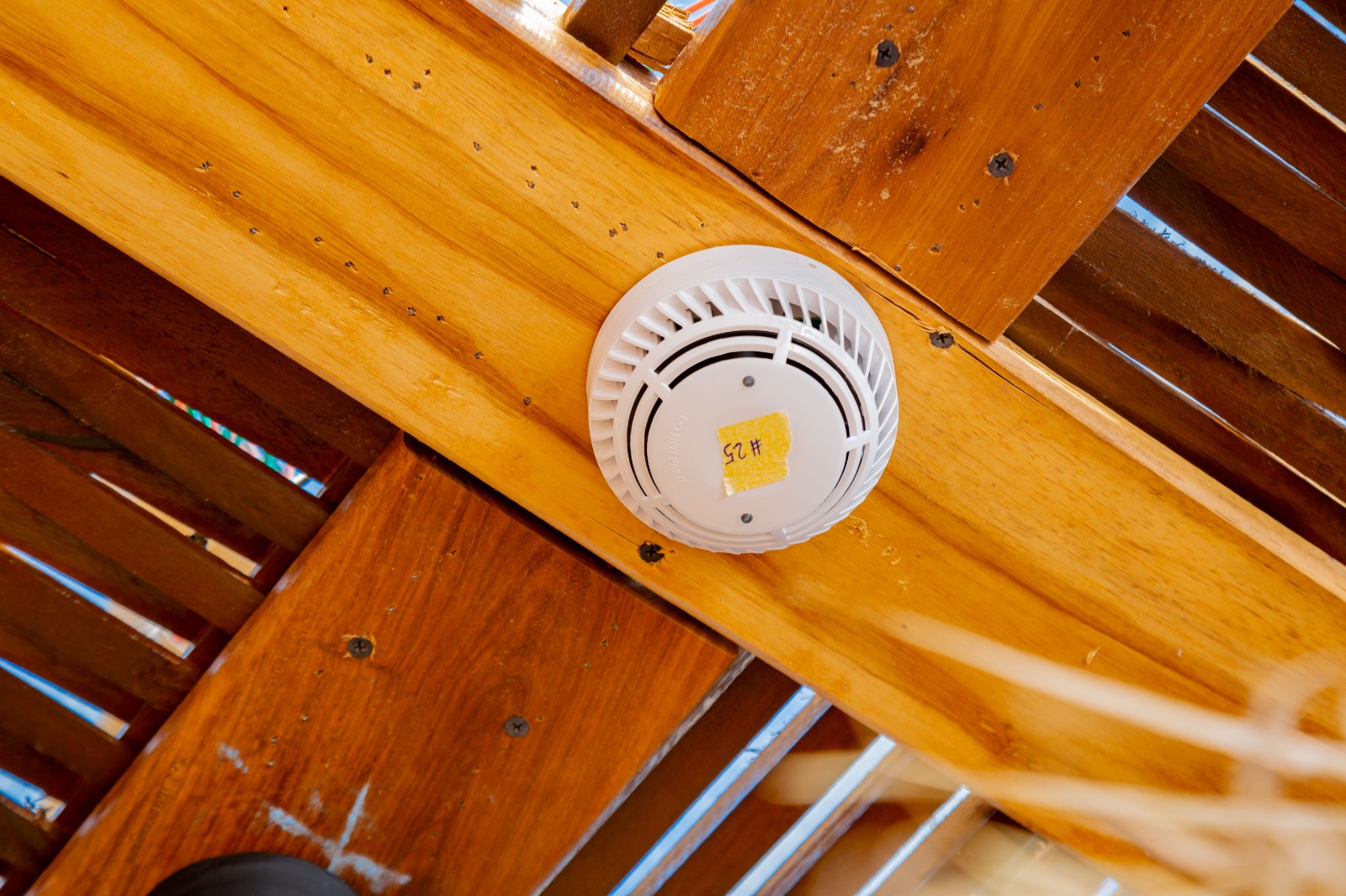 Fire alarm detector mounted overhead for fire safety monitoring